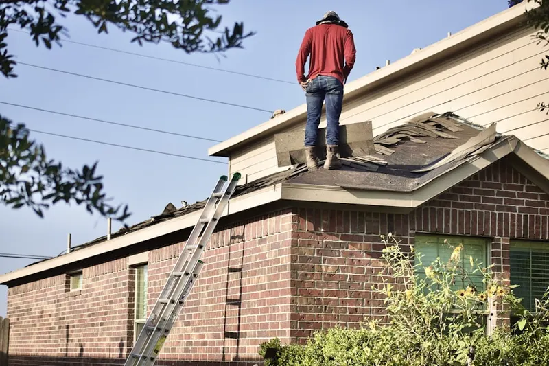 Professional roofer working on a residential roof in Grosse Pointe Farms